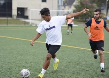 UB soccer player kicking the ball